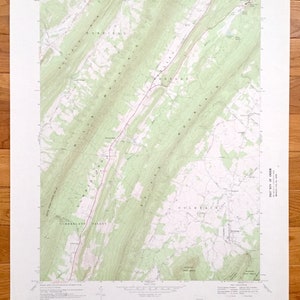 May include: A vintage topographic map of the Colerain area in Pennsylvania. The map shows the location of roads, rivers, and mountains. The map is printed on a white background with green and brown lines.