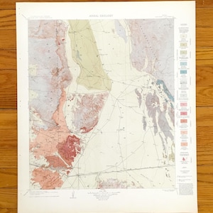 May include: A vintage map labelled "AREAL GEOLOGY" showing a geological layout. The map uses beige, pink, and green colours, with a legend on the right. The map is printed on aged paper, with a detailed design.