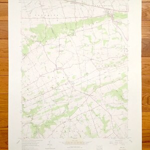 May include: A vintage topographic map of the Paradise, PA area. The map shows roads, rivers, and other geographical features. The map is printed on white paper and has a light green tint.