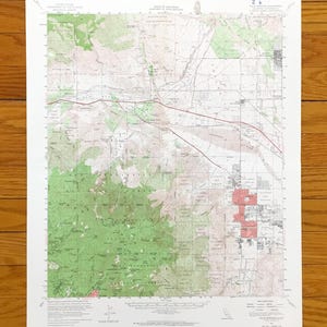 May include: A vintage topographic map of Palm Springs, California, featuring detailed contour lines, roads, and geographical features. The map is printed on aged paper, with green, brown, and red hues. The map is labeled "State of California" and "Palm Springs, Calif."