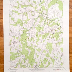 May include: A vintage topographic map of the Danville Quadrangle in Virginia. The map is printed on cream-coloured paper and shows the area's terrain with green and brown lines. The map includes the text "DANVILLE QUADRANGLE" in the top right corner.