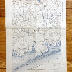 May include: A vintage map of Long Island Sound, New York, showing the coastline, rivers, and towns. The map is printed on a white background with blue lines and text. The map is titled "Long Island Sound" and includes the text "State of New York" and "Department of the Interior."