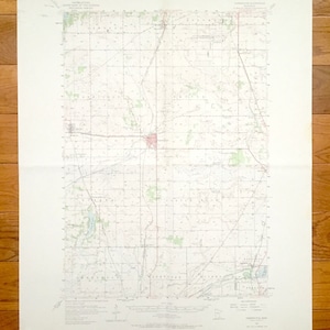 Peut inclure: Une carte topographique vintage de la région de Farmington, Missouri. La carte montre les routes, les rivières et autres caractéristiques géographiques. La carte est imprimée sur du papier et a une couleur brun clair.