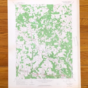 May include: A vintage topographic map showing green shaded forests and white open land. Red lines mark roads, and black lines indicate other features. The map is titled "Mount Chestnut PA".