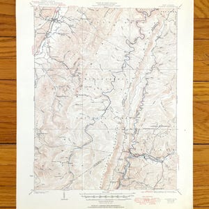 May include: A vintage topographic map of the Monongahela National Forest in West Virginia. The map shows the location of rivers, streams, roads, and elevation contours. The map is printed on a cream-colored paper with red and blue lines.