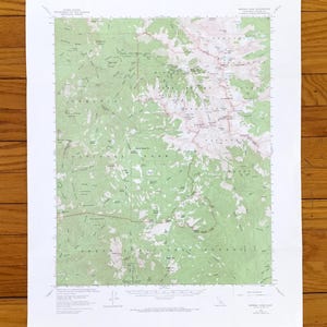 May include: A topographic map of the Sequoia National Park in California, showing the location of various trails, lakes, and mountains. The map is printed on white paper and has a green and brown color scheme.