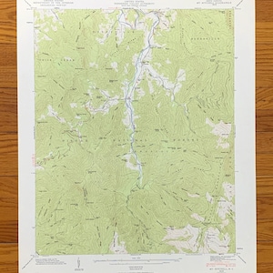 May include: A vintage topographic map of the Mt. Mitchell, North Carolina area, showing the Pisgah National Forest. The map is printed on a white background with green and brown lines indicating elevation and terrain.