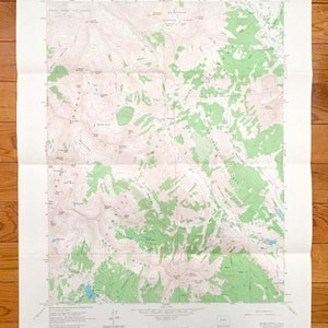 May include: A topographic map of the United States Geological Survey, showing the area around the "South Ridge" in the "Grand Teton National Park" area. The map shows elevation contours, rivers, lakes, and other geographic features. The map is printed on white paper with green and brown ink.