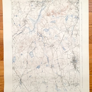 May include: A vintage map of Massachusetts, showing the towns of Westboro, Northboro, Shrewsbury, Grafton, and West Boylston. The map is printed on cream-coloured paper with blue and brown lines.