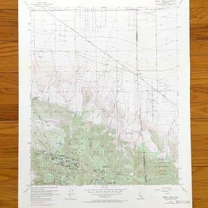 May include: A United States Geological Survey topographic map of Mescal Creek, California. The white paper map features detailed contour lines, green shaded forest areas, and black text labels indicating geographical features and data.
