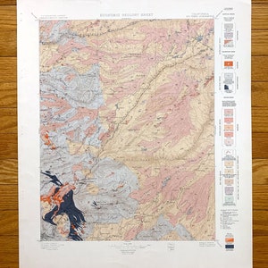 May include: A vintage geological map of California, showing the distribution of various rock types and formations. The map is printed in black, red, and blue ink on a white background. The map is titled "Economic Geology Sheet" and includes a legend with various symbols and colors.