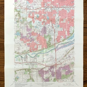 May include: A vintage map of Bloomington, Minnesota, showing roads, rivers, and other geographical features. The map is printed on paper and has a light brown color. The map is titled "Bloomington Quadrangle" and includes the text "U.S. Geological Survey 1:24,000 Series (Topographic)."