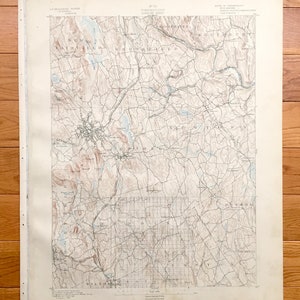 May include: A vintage topographic map of the Canaan, Connecticut area. The map shows the towns of North Canaan, South Canaan, Salisbury, and Falls Village. The map is printed in black and white with brown and blue accents. The map is dated 1903.
