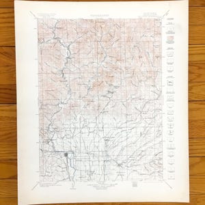 May include: A vintage topographic map with detailed contour lines, rivers, and place names. The map is printed on aged paper, featuring a grid pattern and a legend on the right side. The title "TOPOGRAPHY" is printed at the top.