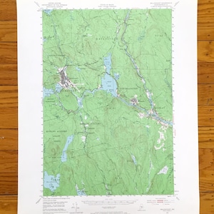 May include: A detailed topographic map of the Millinocket, Maine area, showing contour lines, water bodies, and place names. The map is printed on white paper and displays the landscape in shades of green, blue, and brown. Includes the United States Geological Survey logo.