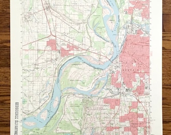 May include: A vintage map of Memphis, Tennessee, showing the Mississippi River and surrounding areas. The map is printed on cream-colored paper with red and blue lines and text. The map is titled "Memphis, Tenn. Area" and includes a scale and legend.