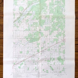 May include: A vintage topographic map of Rock, Minnesota, published by the United States Geological Survey. The map shows the area around Rock, Minnesota, including the surrounding forests, lakes, and rivers. The map is printed on a white background with green lines and text.