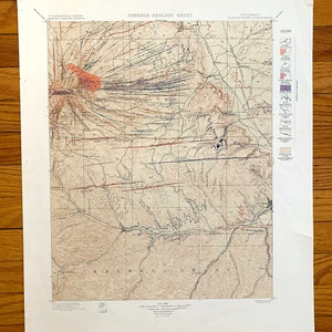 May include: A vintage geological map of the Spanish Peaks, Colorado, showing the area's igneous geology. The map features a detailed legend with various symbols and colors representing different rock types and formations. The map is titled "Igneous Geology Sheet" and includes the text "U.S. Geological Survey" and "Colorado, Spanish Peaks Quadrangle".