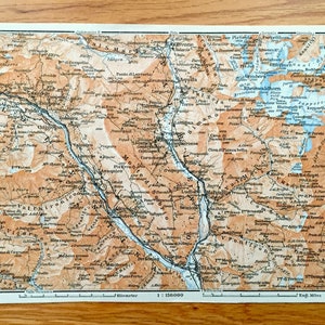 May include: An antique map of the Italian Alps, featuring a detailed topographic map with brown and blue lines and text in Italian. The map shows the region around Lake Idro and the surrounding mountains.