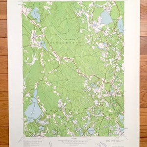 May include: A vintage topographic map of Middleborough, Massachusetts, showing the surrounding area, including lakes, rivers, and roads. The map is printed on paper and has a green and brown color scheme.