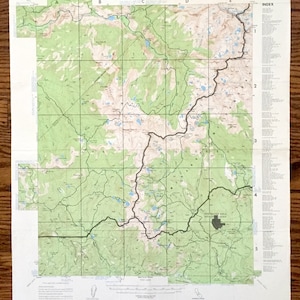 May include: A vintage map of the Mount Pinos Quadrangle in California. The map is divided into sections labeled A through E and numbered 1 through 5. The map shows the terrain, roads, and trails in the area. The map is printed on a white background with green and brown lines and text. The map is titled "Mount Pinos Quadrangle, California".