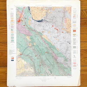 May include: A vintage geological map titled "Economic Geology Sheet" of California. The map features a detailed illustration with various colors representing different geological formations. Includes a legend and is printed on aged paper.