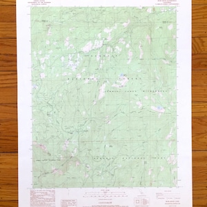 May include: A topographic map of Sequoia National Forest and Kings Canyon National Park, with green and white shaded relief. The map includes text indicating the area's features and the U.S. Department of the Interior. The map is on a white background.