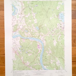 May include: A vintage topographic map of the Middletown, Connecticut area, featuring the Connecticut River. The map shows detailed geographical features, including rivers, forests, and towns, with a color scheme of green, blue, and brown.