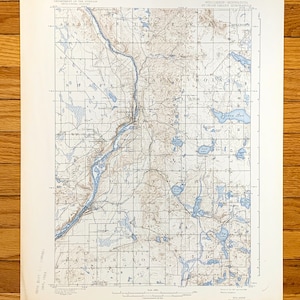May include: A vintage map of the Saint Croix Dalles Quadrangle in Wisconsin and Minnesota. The map shows the area's topography, rivers, lakes, and towns. The map is printed in black and white with blue lines for water features.
