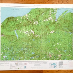 May include: A vintage map of the Iron River area in Michigan, featuring a detailed topographic map with green and blue colors. The map includes the text "IRON RIVER" in the top center and "EASTERN UNITED STATES 1:250,000" in the top left corner.