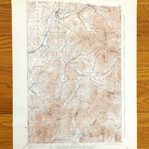 May include: A vintage topographic map with brown and white details. The map features contour lines, rivers, and place names such as Montgomery and Richford. The map is printed on aged paper and has text at the top and bottom.