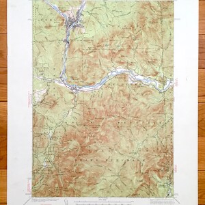 May include: A vintage topographic map of the White Mountains region, featuring detailed contour lines, rivers, and towns. The map is printed on aged paper, with text indicating the U.S. Department of the Interior and the National Forest. The map shows the towns of Berlin and Shelburne.