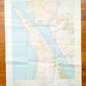 May include: A vintage map of the United States Geological Survey, showing the area around the San Francisco Bay. The map is printed on a light beige paper and includes details such as roads, rivers, and elevation contours. The map is titled "San Francisco South Quadrangle, California" and includes the text "UNITED STATES DEPARTMENT OF THE INTERIOR GEOLOGICAL SURVEY".