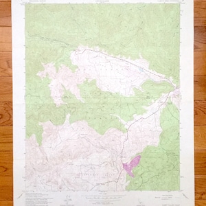 May include: A vintage topographic map of the Curry Valley, California region. The map features contour lines, elevation markings, and geographical details in shades of green, white, and purple. The map is printed on aged paper and includes text indicating the map's origin and scale.