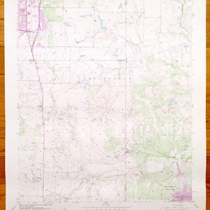 May include: A vintage topographic map from the U.S. Department of the Interior, Geological Survey. The map features contour lines, roads, and geographical features in shades of green, purple, and blue. The title "BLOOP CREEK QUADRANGLE" is visible.