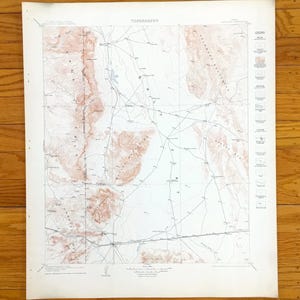 May include: A vintage topographic map, with the word "TOPOGRAPHY" at the top. The map shows brown and white terrain details, with lines indicating roads and other features. A legend is on the right side.