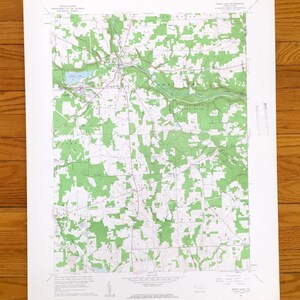 May include: A vintage topographic map of Barry Lake, Pennsylvania, featuring green shaded areas representing forests and white areas for open land. The map includes roads, rivers, and a lake, with text indicating the map's title and survey details.