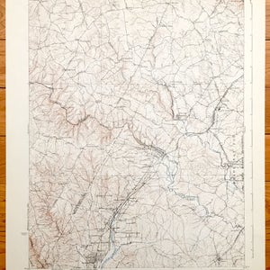 May include: A vintage topographic map of the area around the town of La Plata, Maryland. The map shows roads, rivers, and elevation changes. The map is printed on paper and has a brown and white color scheme.