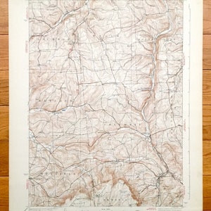 Op de afbeelding: Een vintage topografische kaart van het gebied van Columbia, Pennsylvania. De kaart toont het terrein, de wegen en waterwegen van de regio. De kaart is gedrukt op crèmekleurig papier en heeft een bruin en beige kleurenschema.