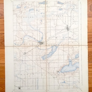 May include: A vintage map of the Elkhart, Indiana area, showing the towns of Elkhart, Goshen, Bristol, and surrounding areas. The map is divided into sections, with each section labeled with the name of a township. The map also shows the location of various bodies of water, including the Elkhart River, the St. Joseph River, and Lake Geneva.