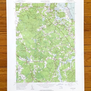 May include: A vintage topographic map of the area around the town of  "Marshfield" in Massachusetts. The map is printed on paper and shows roads, rivers, and other geographical features. The map is in black, green, and red.