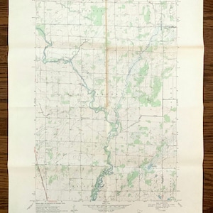 May include: A vintage map of the Princeton, Minnesota area, showing Bogus Brook and the surrounding area. The map is printed on cream-coloured paper and includes contour lines, roads, and other geographical features.