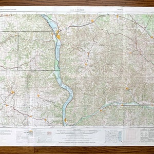 May include: A vintage map of La Crosse, Wisconsin, printed on a white background with black lines and text. The map shows the city and surrounding area, including rivers, roads, and other geographical features. The map is titled "LA CROSSE" in the upper right corner.