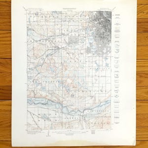May include: A vintage topographical map of a region in Minnesota, featuring detailed grid lines, roads, and water bodies. The map is printed on aged paper with the word "TOPOGRAPHY" at the top. The map includes a legend and various place names.