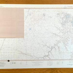 May include: A large, detailed topographic map of Los Angeles County, Colorado, with a grid overlay and shaded relief features. The map has a pink-toned section in the upper left corner and is printed on white paper.