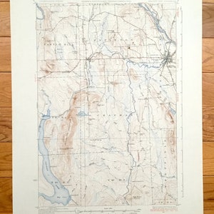May include: A vintage topographic map of the Chapman, Maine area. The map shows the location of roads, rivers, lakes, and other geographical features. The map is printed on a cream-colored paper and has a light brown tint.