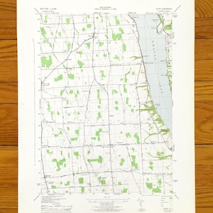 May include: Vintage topographic map of the Sodus Quadrangle in New York, featuring detailed contour lines, roads, and green shaded areas representing forests. The map includes the scale 1:11,000 and is printed on aged paper.