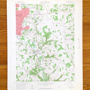 May include: A vintage topographic map of an area in Pennsylvania, featuring detailed contour lines, green shaded areas representing forests, and a pink-shaded area. The map is printed on aged paper and includes text indicating the map's origin.