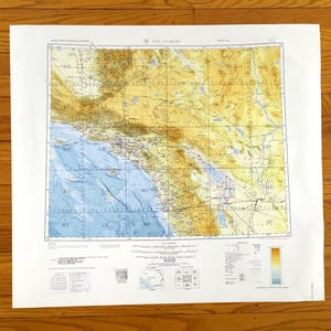 May include: A detailed map of Los Angeles, California, with topographical features and grid lines. The map includes the Pacific Ocean and surrounding areas, with text indicating locations and elevations. The map is printed on white paper.