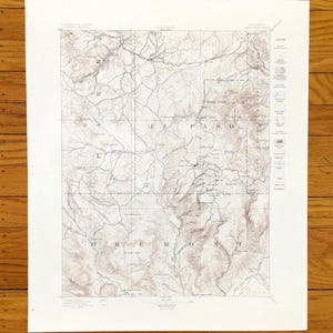 Puede incluir: Un mapa topográfico antiguo de las áreas de El Paso y Fremont en Colorado. El mapa presenta líneas de contorno detalladas, carreteras y características geográficas en tonos marrones y beige. El mapa está impreso en papel envejecido con un borde blanco.
